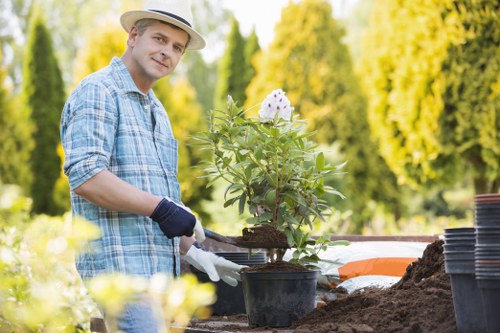 Worker using protective equipment during garden maintenance